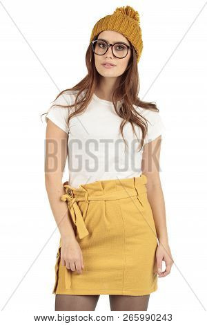 Cute Smiling Preppy, Fashion Geek Girl In A White T-shirt And Yellow Skirt