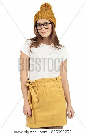 Cute Smiling Preppy, Fashion Geek Girl In A White T-shirt And Yellow Skirt