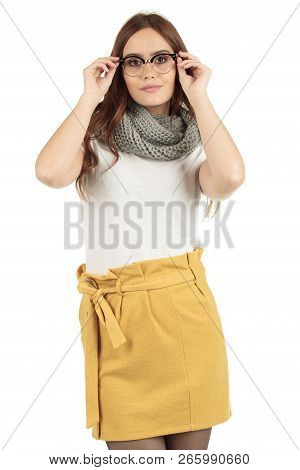Cute Smiling Preppy, Fashion Geek Girl In A White T-shirt And Yellow Skirt