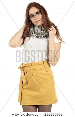Cute Smiling Preppy, Fashion Geek Girl In A White T-shirt And Yellow Skirt
