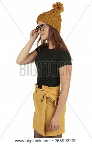 Cute Smiling Preppy, Fashion Geek Girl In A Black T-shirt And Yellow Skirt