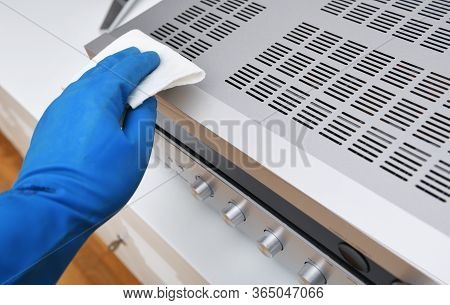 Worker's Hand Wipes Dust And Dirt On Household Appliances. A Maid Or Housewife Takes Care Of The Hou