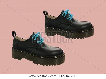 Black Leather Platform Shoes Isolated On Pink Background. Classic Shoes On A High Black Tractor Plat