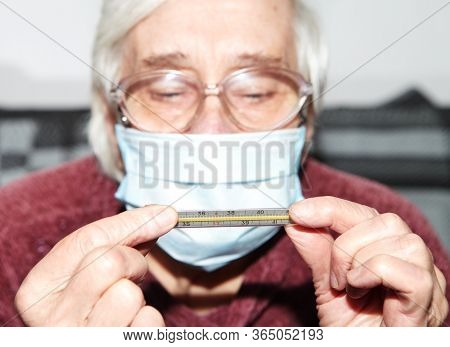 Elderly Woman In A Medical Mask. The Epidemic