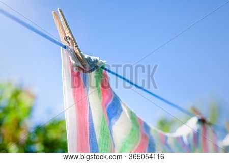 Freshly washed towels or sheets hanging to dry on a clothes line.