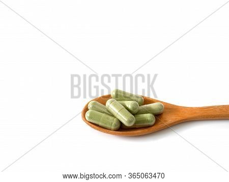 Andrographis Paniculata Extract Capsules Or Creat, Green Chireta In Wooden Spoon