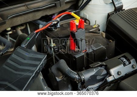 Engine Engineer Is Recharging Car Battery Because Car Battery Is Depleted. Concept Car Maintenance.s