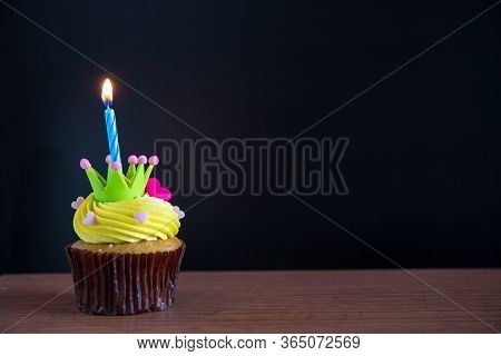Birthday Cupcake With A Single Blue Candle.cupcake With Yellow Cream And Heart For Love Valentines.g