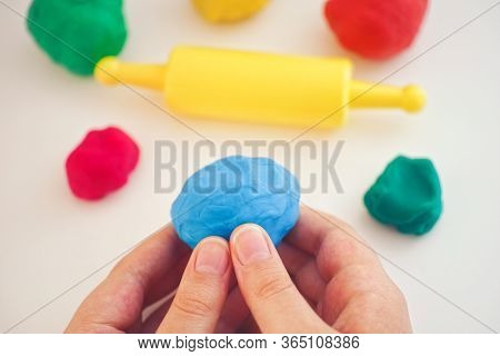 Child Playing Playdough. Play Clay In Hands. Close Up.