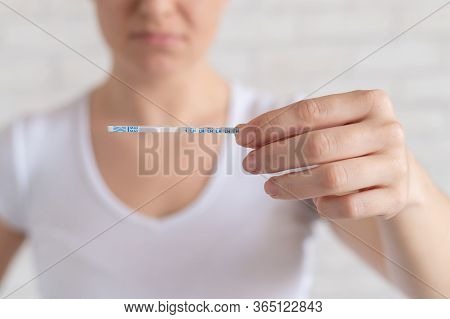 Unhappy Woman Shows A Quick Negative Test For Ovulation. The Concept Of Violation Of Female Reproduc