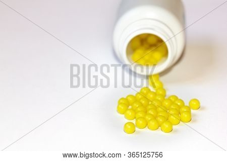Round Yellow Vitamin C Tablets On A White Background. Ascorbic Acid Close-up. Vitamin C For The Trea