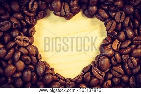 Roasted Brown Coffee Beans With Empty Heart Form Shape.
