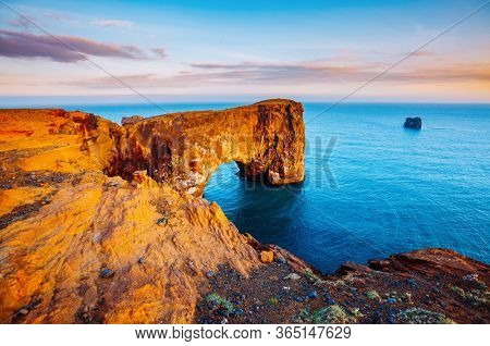 Fantastic large arch of lava in Atlantic Ocean on the coast. Location place Sudurland, cape Dyrholaey, Iceland, Vik village, Europe. Photo of popular tourist attraction. Discover the beauty of earth.