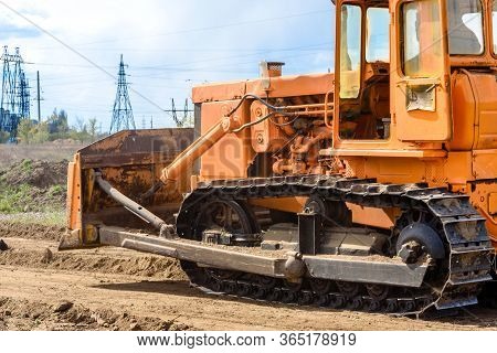 Industrial Building Construction Site Bulldozer Leveling And Moving Soil During Highway Building. Ye