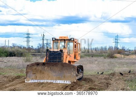 Industrial Building Construction Site Bulldozer Leveling And Moving Soil During Highway Building. Ye