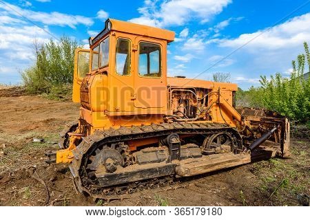 Industrial Building Construction Site Bulldozer Leveling And Moving Soil During Highway Building. Ye