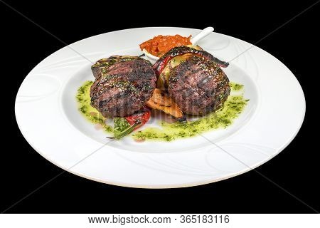 Tasty Beef Meatballs With Ljutenica, And Spices On A Plate, Isolated On Black Background