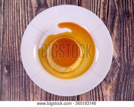 Tasty Caramel Custard With Eggs, Milk, And Sugar On A Plate. Top View