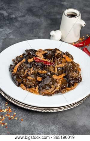 Wood Mushrooms With Meat In A White Plate On A Gray Background