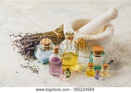 Aromatic Oils In Glass Bottles, Aromatic Salts, Marble Mortar And Dry Lavender. Concept Natural Ogra