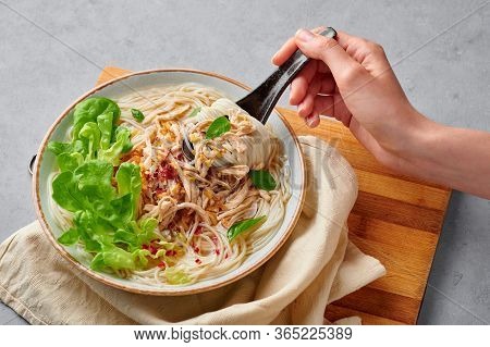 Guay Tiew Gai Cheek Or Thai Chicken Noodle Soup In White Bowl On Gray Concrete Backdrop. Guay Tiew G