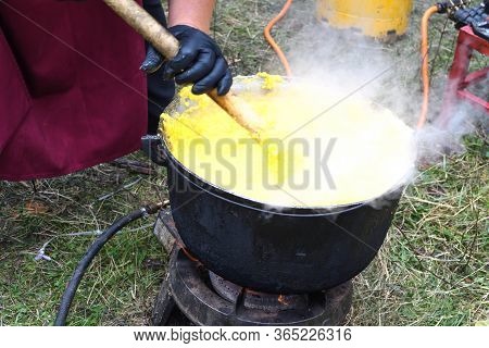 Very Large Cauldron Cooking Food During Campfire, Big Pots On Fire Preparing During Food Festival. T