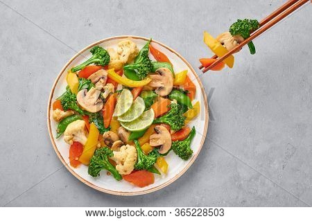 Pad Pak Ruam Or Veg Thai Stir-fried Vegetables In White Plate On Gray Concrete Backdrop. Pad Pak Is