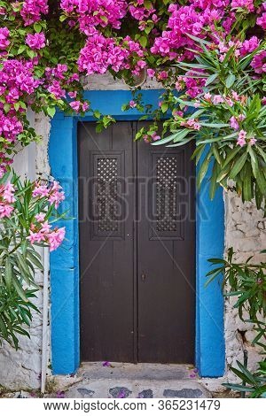 Pink Bougainvillea Flowers And Old Blue Door At Bodrum. Mugla, Turkey
