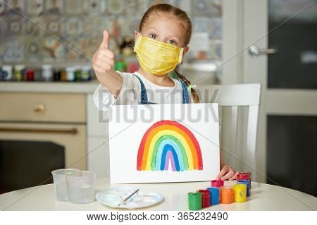 Thank To Nhs. Kid In Protective Mask Painting The Rainbow During Covid-19 Quarantine At Home. Corona