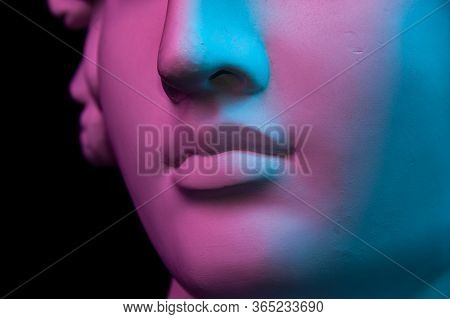 Colorful Gypsum Copy Of Ancient Statue Of Human Head For Artists On A Black Background. Close Up Vie
