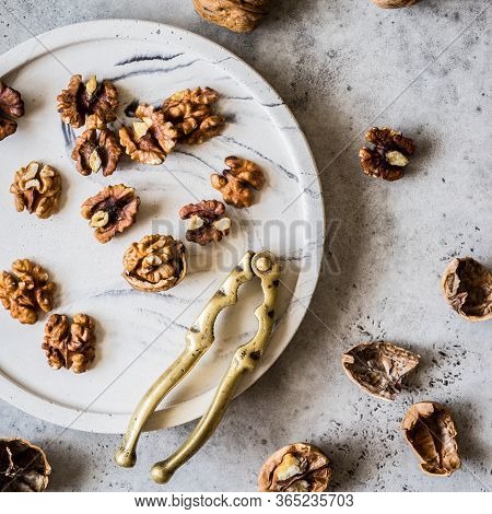 Cracking Walnuts With A Brass Nut Cracker, Square