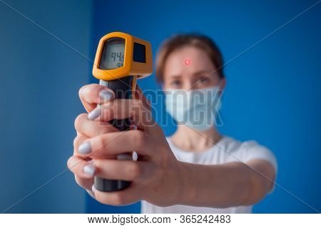 Healthcare, Measurement, Disease, Infection, Coronavirus Concept. Woman In Medical Face Mask Holding