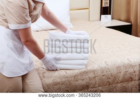 The Maid Changes Towels In The Hotel Room.unrecognizable Photo. The Concept Of The Hotel Business.