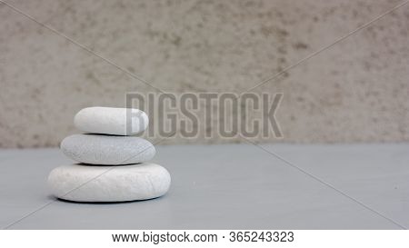 Tree Grey Roundstones On Clear Gray Background. Spa Stones, Zen Like Concept. Pastel Colors