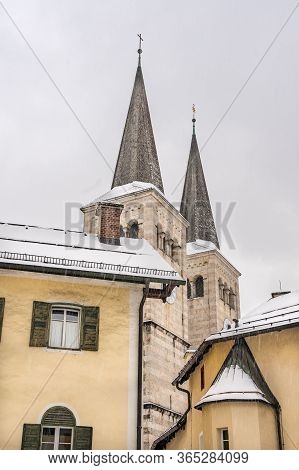 Steeple Of Stiftskirche St. Peter Und Johannes Der Taufer In Berchtesgaden, Germany With Snow