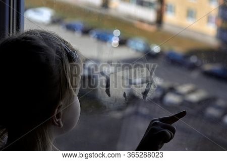 Girl Looks Lonely Through Window By Putting Her Hands On Window Sill