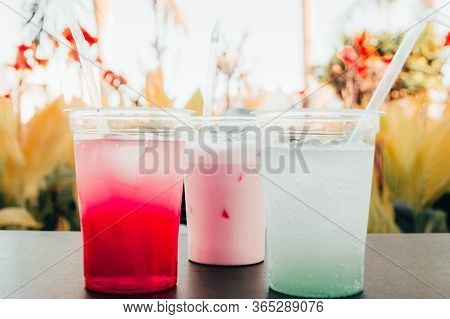 Straws In Refreshing Cold Cocktails. Strawberry And Peppermint Drinks In Hot Summer Day At The Beach