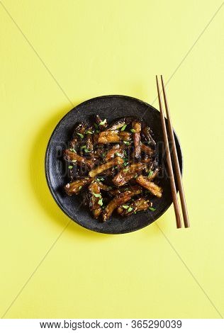 Stir-fry Bulgogi Eggplant On Plate Over Yellow Background With Freee Text Space. Fried Aubergine In 
