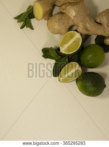 Close-up Of Ginger Root, Mint Leaves And Lime Fruits. Healthy Drink. Tea Supplement. Cold Remedy. He