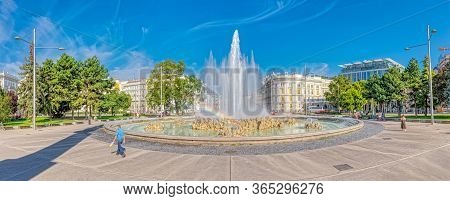 Vienna, Austria September 7, 2018: People Walking By Fountain At The Soviet War Memorial More Formal