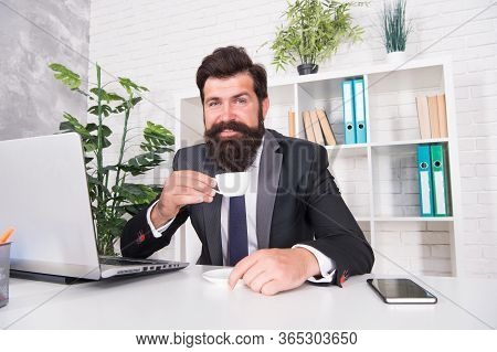 Man Handsome Boss Sit In Office Drinking Coffee. Comfy Workspace. Bearded Hipster Formal Suit Relaxi