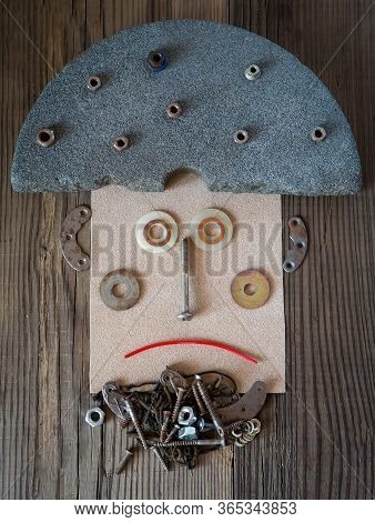 Creative Man's Portrait From Metal, Plastic Details And Paper On The Wooden Background