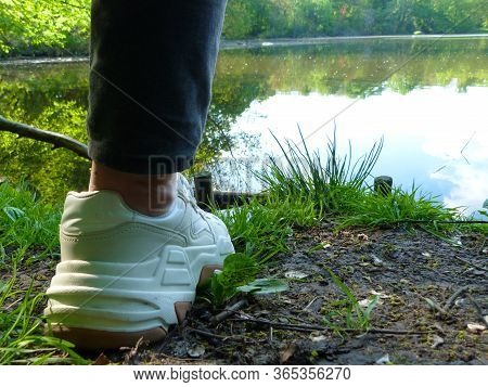 One Leg Of A Girl In Front Of A Lake