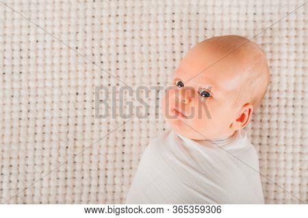 Newborn On The Bed. Crying, Screaming Baby Close Up And Copy Space. Baby Smile And Colic In Newborns
