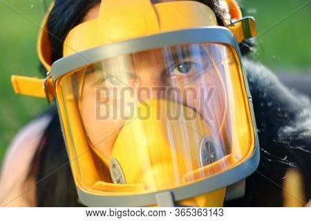 Woman in protection mask on a meadows. Allergy and infection control concept. Hayfever or covid-19 hazard.