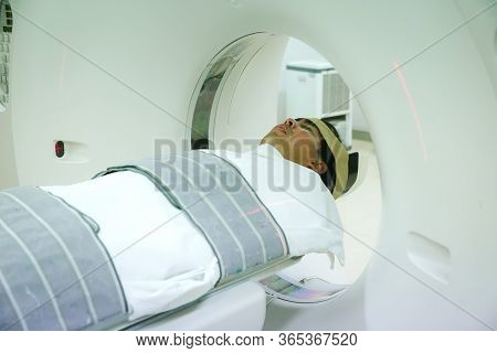 Patients Screening On Ct Scanner. Man Undergoing Ct Scan While Doctor\'s Using Computers. Examining 