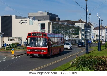 Llandudno, Uk : May 6, 2019: A Classic Leyland National Bus In Midland Red Livery Drives Past The Ve
