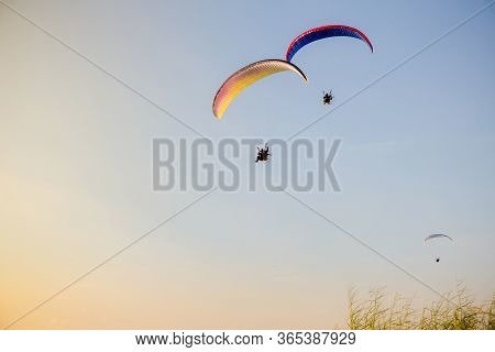 Paramotors Flying To Sky On Sunset Adventure Man Active Extreme Sport Pilot Flying In Sky With Param