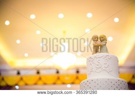 Figurines Of The Bride And Groom On A Wedding Cake Corny Wedding Cake That Symbolizes The Commitment