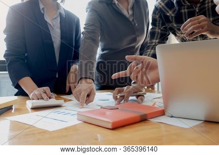 Businesswoman Holding Pens And Holding Graph Paper Are Meeting To Plan Sales To Meet Targets Set In
